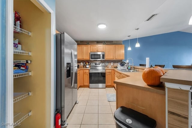 kitchen with stainless steel appliances, sink, light tile patterned floors, light brown cabinets, and hanging light fixtures