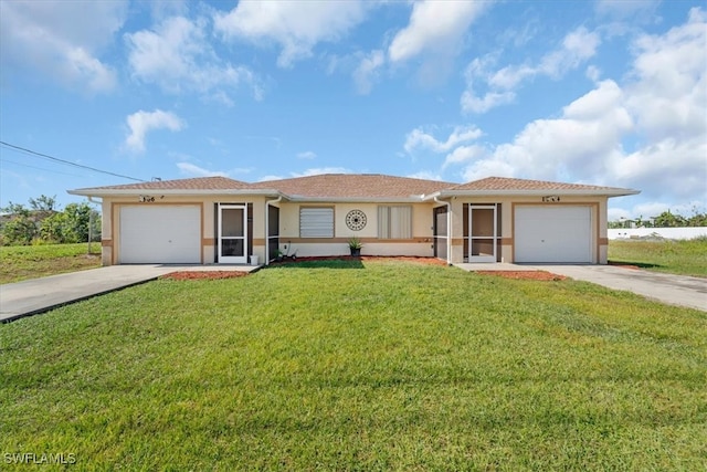 view of front of home with a garage and a front lawn