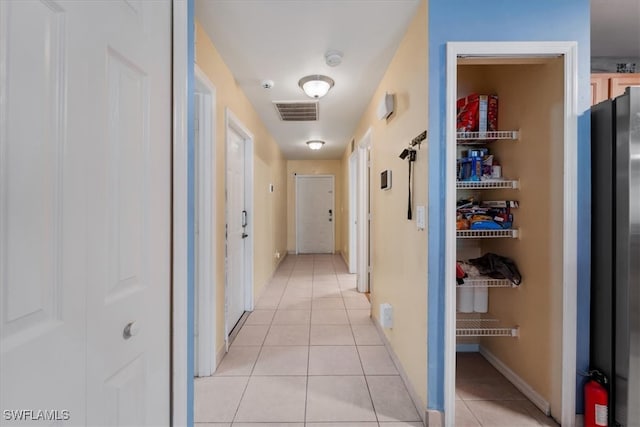 corridor with light tile patterned flooring