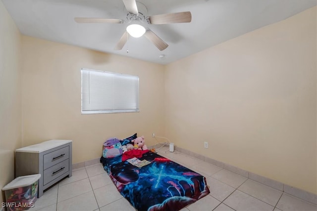 tiled bedroom featuring ceiling fan