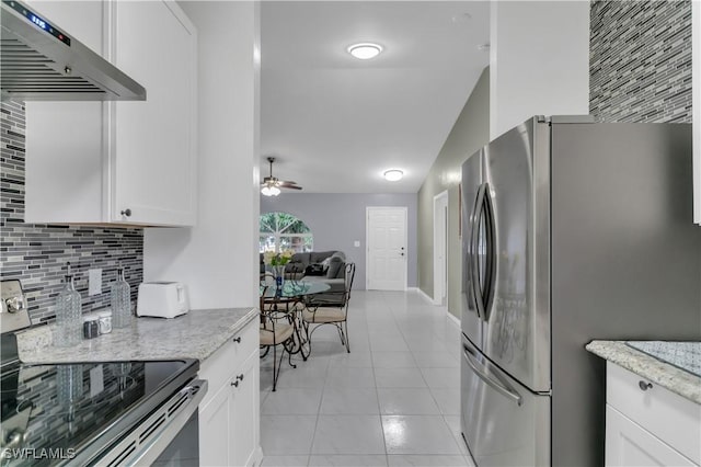 kitchen with white cabinets, appliances with stainless steel finishes, and range hood