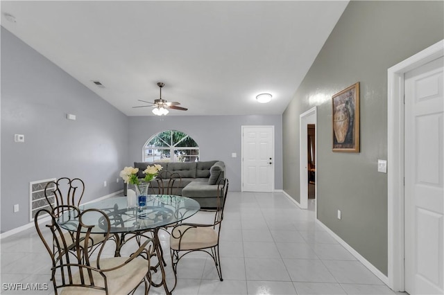 tiled dining room with vaulted ceiling and ceiling fan