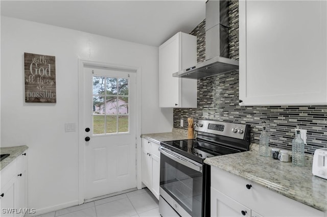 kitchen featuring white cabinets, stainless steel electric range, light stone countertops, and wall chimney range hood