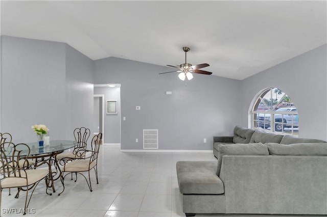 living room featuring ceiling fan, light tile patterned flooring, and lofted ceiling