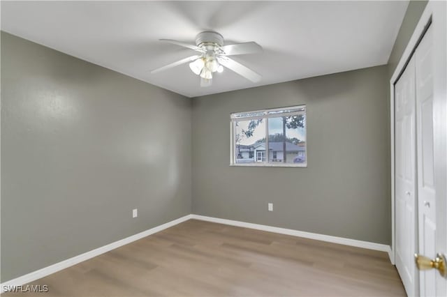 unfurnished bedroom with ceiling fan, a closet, and light hardwood / wood-style flooring