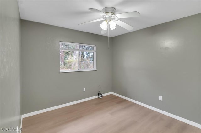 spare room with ceiling fan and wood-type flooring