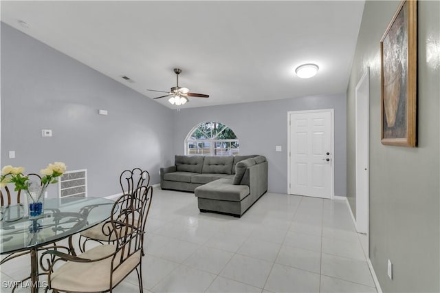 tiled living room featuring ceiling fan and lofted ceiling