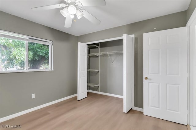 unfurnished bedroom with light wood-type flooring, a closet, and ceiling fan