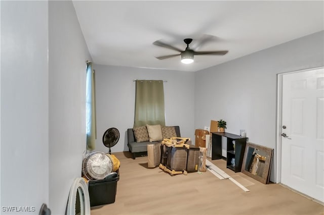 sitting room featuring light hardwood / wood-style floors and ceiling fan