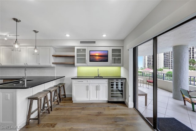 4451 Gulf Shore Blvd N Unit 506, Naples, FL 34103 - kitchen featuring beverage cooler, open shelves, white cabinetry, dark countertops, and recessed lighting