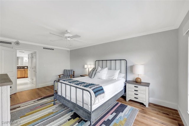 bedroom featuring ceiling fan, crown molding, connected bathroom, and light hardwood / wood-style flooring