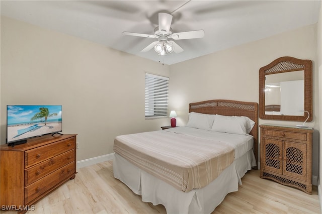 bedroom with light hardwood / wood-style flooring and ceiling fan