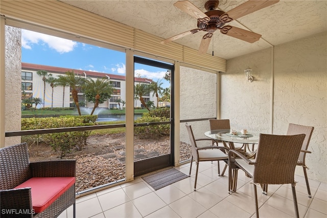 sunroom featuring ceiling fan