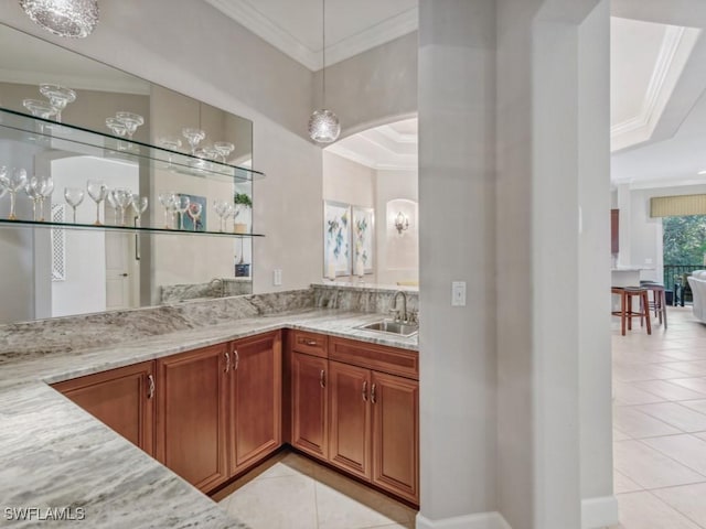 bar with crown molding, sink, light stone counters, and light tile patterned flooring