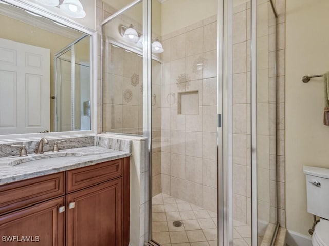 bathroom with toilet, a shower with door, crown molding, and vanity