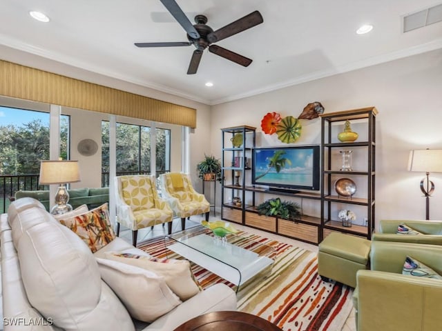 living room with ceiling fan and ornamental molding