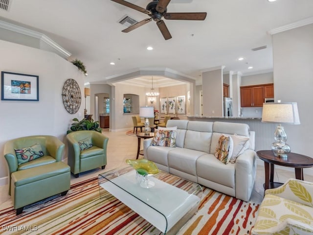 living room featuring ceiling fan with notable chandelier and ornamental molding