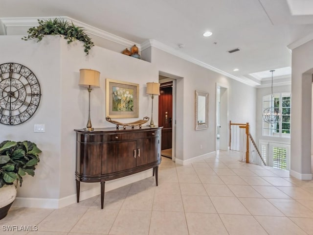 hallway with light tile patterned floors, crown molding, and a chandelier