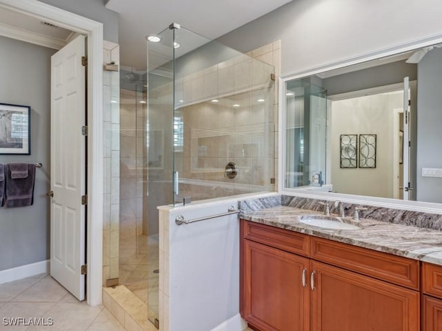 bathroom with an enclosed shower, vanity, and tile patterned floors