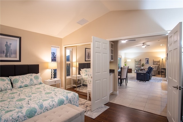 bedroom with a closet, hardwood / wood-style floors, and vaulted ceiling