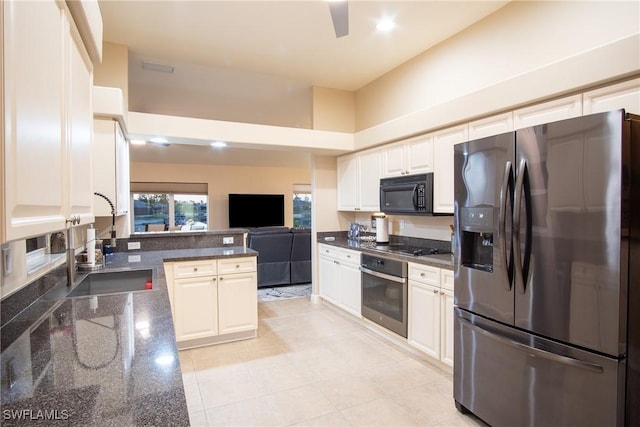 2902 SW 10th Pl, Cape Coral, FL 33914 - kitchen featuring appliances with stainless steel finishes, a sink, dark stone countertops, open floor plan, and white cabinets