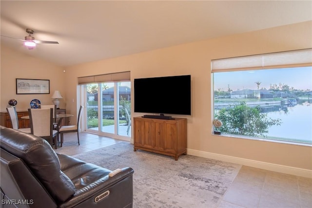 2902 SW 10th Pl, Cape Coral, FL 33914 - tiled living room featuring ceiling fan, lofted ceiling, and baseboards