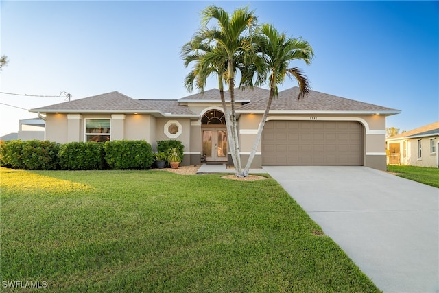 view of front of house featuring a front yard and a garage