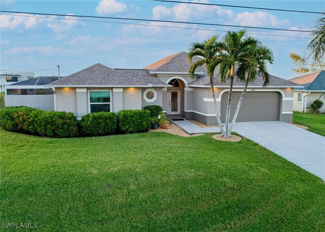 ranch-style house with a front yard and a garage