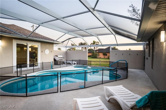 2902 SW 10th Pl, Cape Coral, FL 33914 - view of swimming pool featuring area for grilling, a patio area, glass enclosure, and a pool with connected hot tub