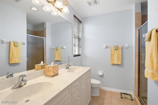 bathroom with tile patterned flooring, vanity, a shower with door, and toilet