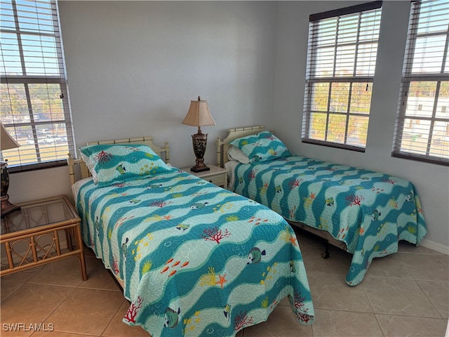 bedroom with light tile patterned flooring and multiple windows