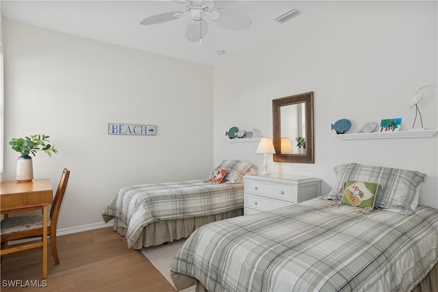 bedroom with light hardwood / wood-style flooring and ceiling fan