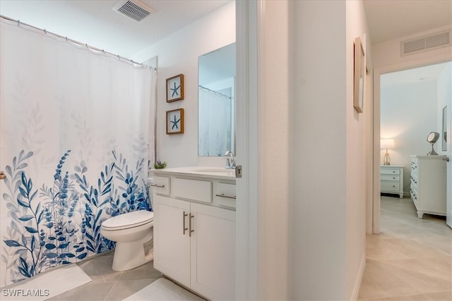 bathroom with tile patterned floors, vanity, and toilet