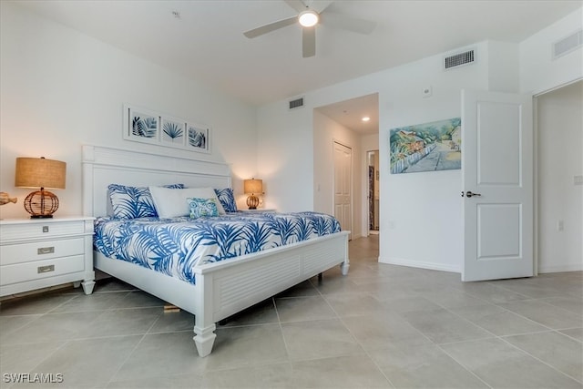 bedroom with ceiling fan, a closet, and light tile patterned floors