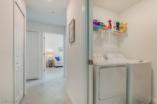 laundry room with light tile patterned floors and separate washer and dryer