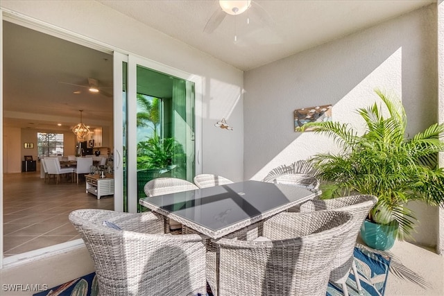 balcony with a patio and ceiling fan