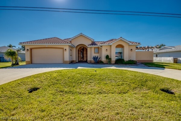 mediterranean / spanish home with a garage and a front lawn