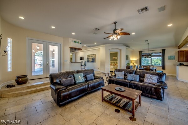 living room with ceiling fan and light tile patterned flooring