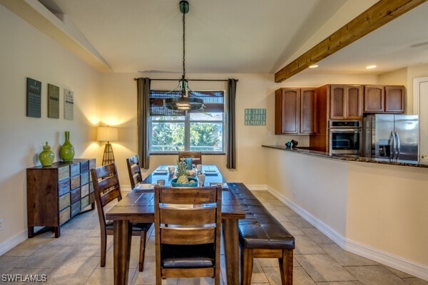 dining area with beam ceiling