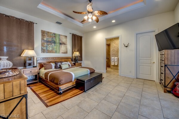 tiled bedroom with ceiling fan, ornamental molding, and a tray ceiling