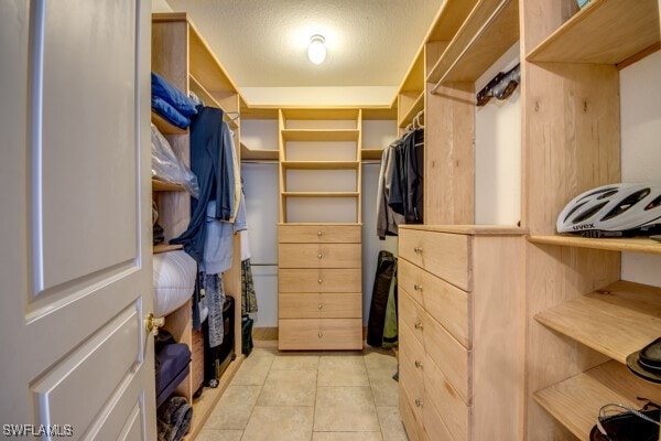 spacious closet with light tile patterned floors