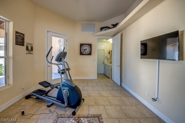 exercise room featuring light tile patterned flooring