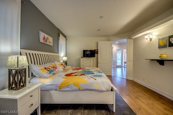 bedroom featuring dark hardwood / wood-style flooring