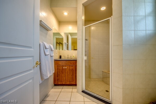 bathroom featuring vanity, tile patterned floors, and walk in shower