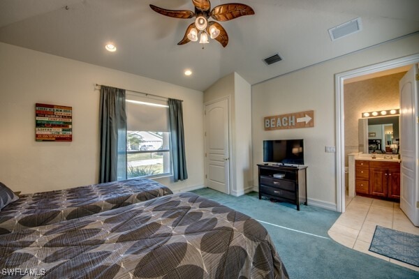 bedroom with light colored carpet, ceiling fan, lofted ceiling, and ensuite bathroom