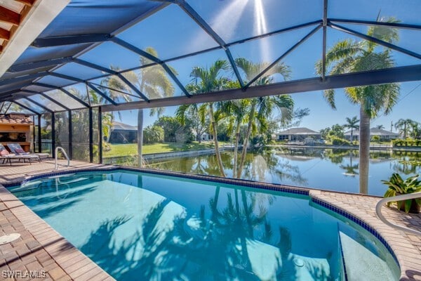 view of pool with glass enclosure, a patio area, and a water view