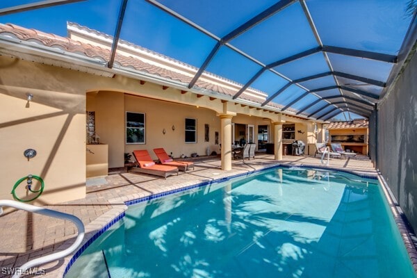 back of property featuring a lanai and a patio