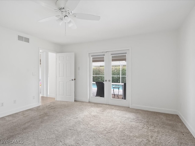 carpeted empty room with french doors and ceiling fan