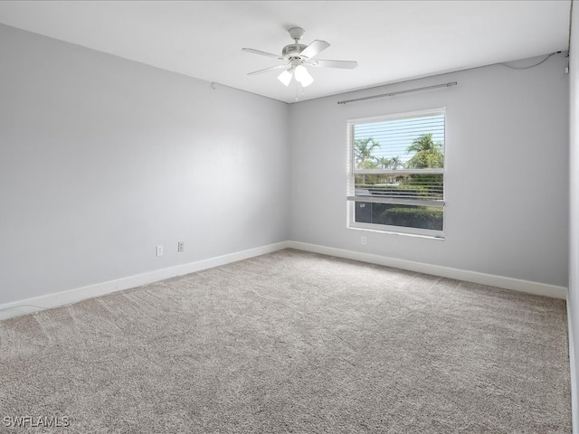 spare room featuring carpet flooring and ceiling fan