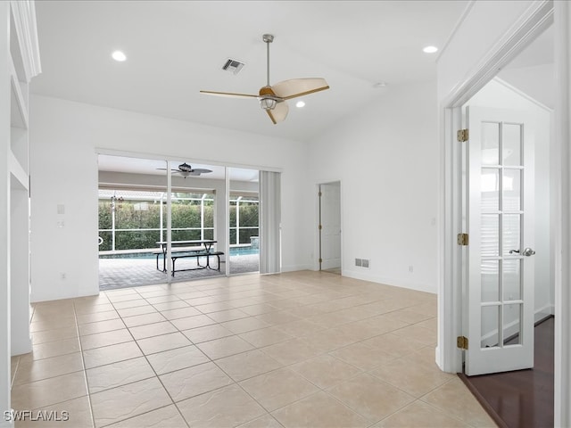 spare room featuring ceiling fan, light tile patterned floors, and lofted ceiling